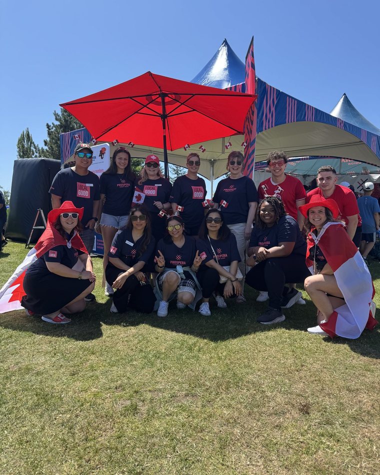 The event team posing together under the tents on Canada Day